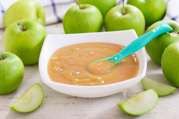 Baby food. Bowl of apple puree with fresh fruits