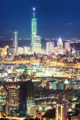Fototapeta na wymiar Night view of Downtown Taipei city, capital city of Taiwan, with view of prominent Taipei 101 tower amid skyscrapers in Xinyi Financial District