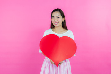 valentine day concept. Beautiful smiley asia girl with pink background copy space isolated.