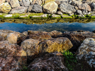 Naklejka na ściany i meble Rocks reflected in the water