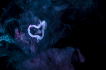 Black background with scattered blue and pink smoke and a gray ring from steam that was made during smoking