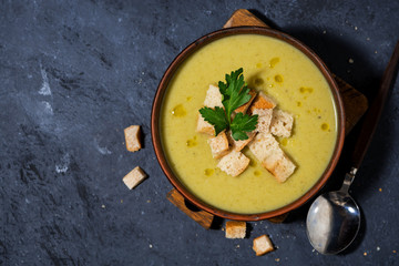 broccoli cream soup with croutons in a bowl for lunch, top view