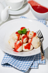 cottage cheese dessert with strawberry sauce, vertical top view