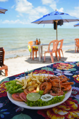 Shrimp dish served at a beach bar on Coroa do Aviao islet, popular destination on the north coast of Pernambuco state (Igarassu, Brazil) © Helissa