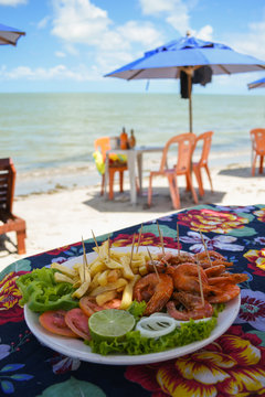 Shrimp dish served at a beach bar on Coroa do Aviao islet, popular destination on the north coast of Pernambuco state (Igarassu, Brazil)