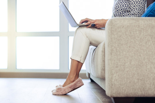 Close Up Of Female Legs In Fluffy Slippers