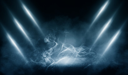Black background of empty street, premises, blue searchlight illuminates asphalt, laser beams, smoke