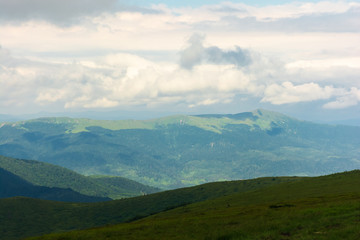 Obraz premium distant mountain ridge in clouds. beautiful summer landscape with cloudy weather