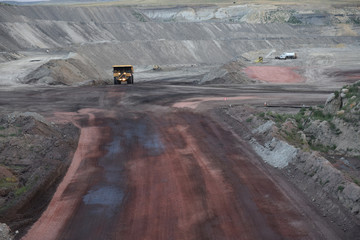 Massive coal mining vehicle driving on a road inside a vast open pit coal mine in the Powder River Basin of Wyoming