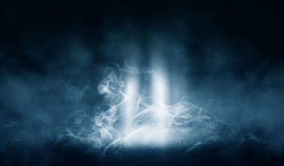 Black background of empty street, room, blue searchlight illuminates asphalt, smoke