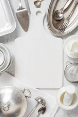 White kitchen background - cutting board decorated with vintage kitchen utensils