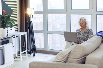 Pleasant nice woman surfing the Internet pages