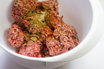 minced meat in a white cup sprinkled with spices