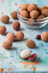 Ripe lychee fruits on an old wooden table.