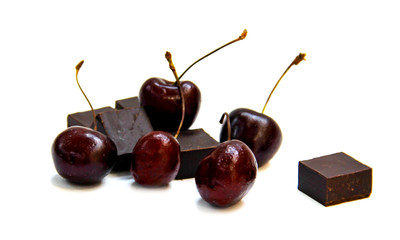 black  chocolate lump and dark large cherry isolated on white