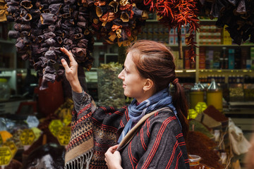 Woman walking on Egyptian spices market in Istanbul, Turkey