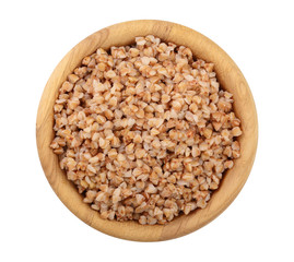Buckwheat porridge in wooden bowl isolated on white background. Top view
