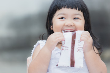 Adorable girl smiling and drink a milk for healthy.