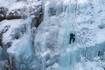 Fototapeta na wymiar Ice climbing the North Greece, man climbing frozen waterfall.