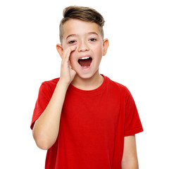 Cute boy in red T-shirt shouting. Speech therapy concept over white background. Front view.