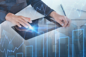 Woman hand on tablet in office, graph