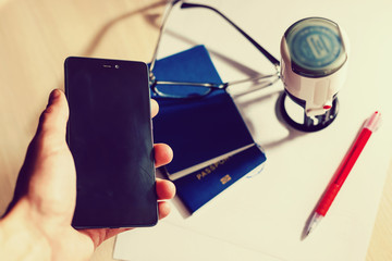 Hands working on digital device network graphic overlay