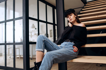 Beautiful girl in a black cap, black golf, blue jeans! Natural light, smart casua, street casual