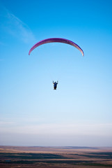 Paraglider in the blue sky