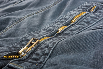 clothing items washed cotton fabric texture with seams, clasps, buttons and rivets