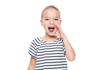 Cute little girl in stripped T-shirt shouting. Speech therapy concept over white background.