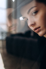 Two hipster models: a man and a woman in a blank black t-shirt, jeans and posing. in a black hat, cap, love, kisses