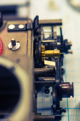 parts old retro film SLR camera on graph paper