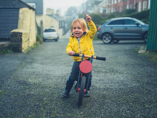 Little toddler riding a balance bike