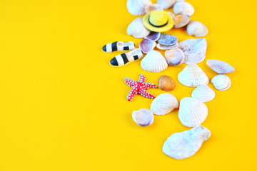 Summer background. Flat lay traveler beach accesories on yellow background with seashells,...