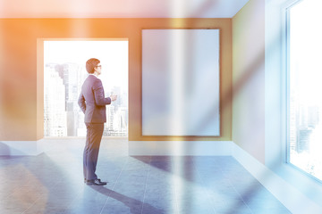 Empty orange room with poster, man