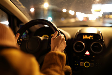 Woman driving car at night
