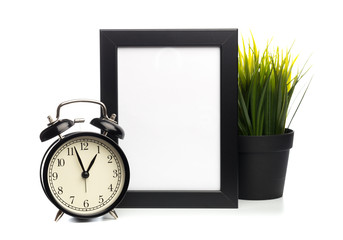 black photo frame and clock isolated on white background, plant behind.