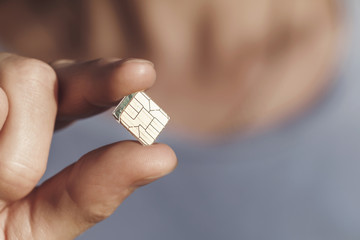 Sim card in hand with copy space, close-up