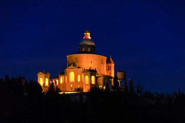 Closeup of scenic Sanctuary of Blessed Virgin of San Luca on Colle della Guardia in Bologna illuminated by night. Historical church and pilgrimage destination in Emilia-Romagna, Italy. Famous landmark © bennymarty