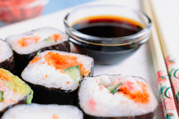 Sushi rolls made from rice, shrimp, flying fish roe and nori, cooked in a fast delivery cafe
