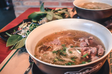 Fresh Pho Bo beef soup in a bowl in Saigon Vietnam