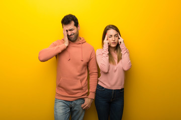 Fototapeta premium Group of two people on yellow background unhappy and frustrated with something