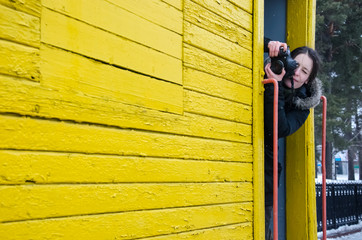 Young woman hold camera, catch focus and make a shot, backstage of photographer profession, process of working people