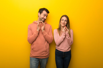 Group of two people on yellow background scheming something - obrazy, fototapety, plakaty