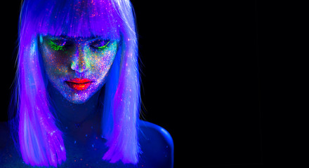 Fashion model woman in neon light. Beautiful model girl with colorful bright fluorescent makeup...