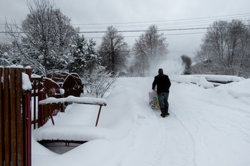 Man removing snow with a snow blower