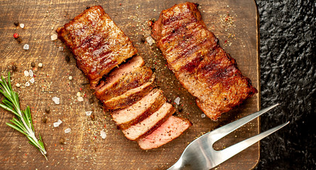 Beef steak on the cutting board with spices