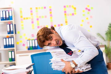 Young employee suffering from excessive work  