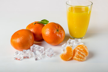 glass of orange juice and oranges isolated on white