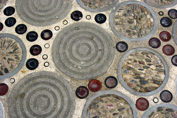 Mosaic of glass bottle bottoms on the pavement pattern